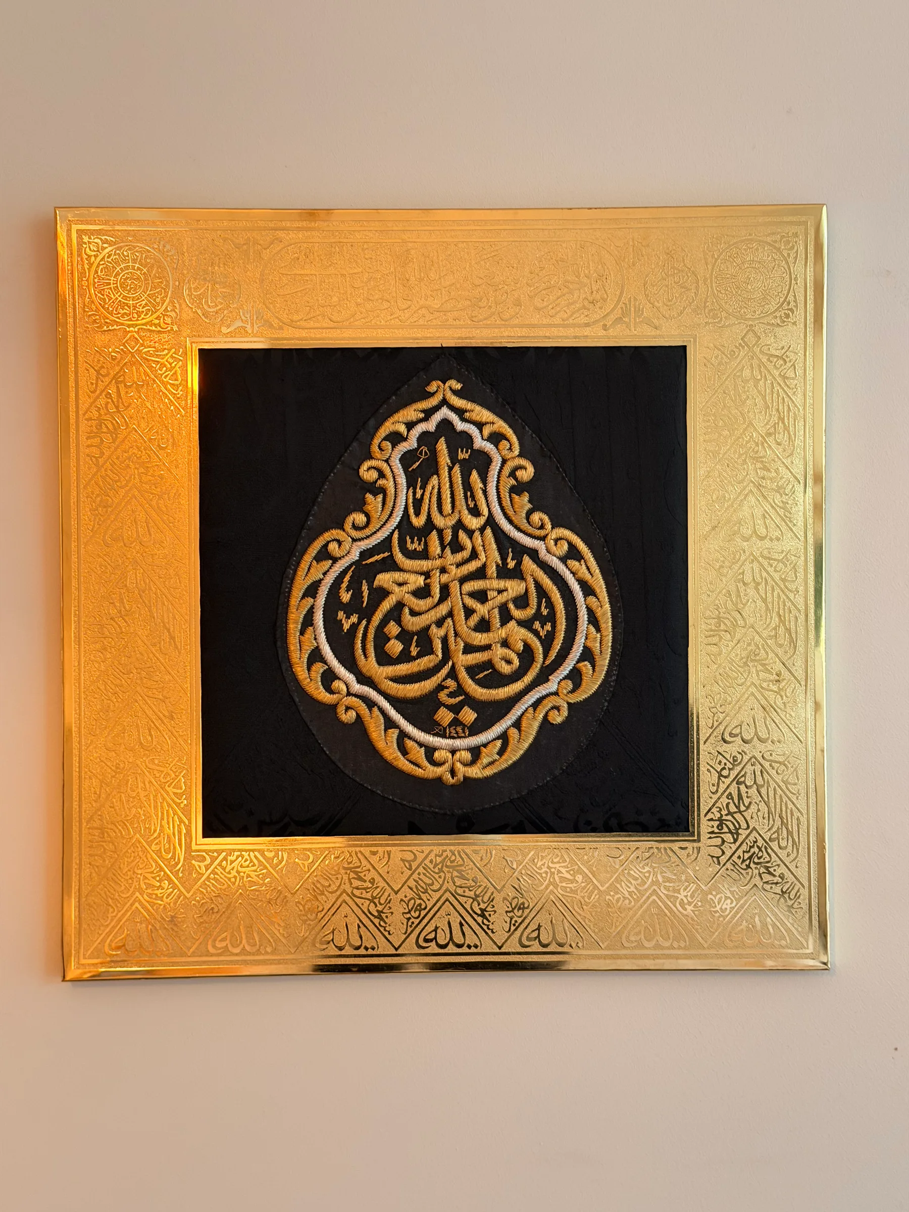 Large Kiswah frame: embroidered calligraphy medallion on black silk in an engraved gilded frame