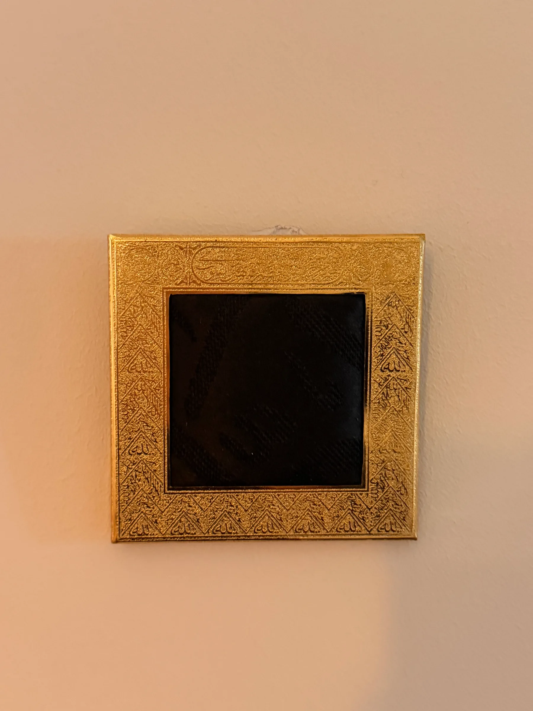 Small Kiswah frame with woven Kiswah fabric in a gilded frame